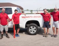 Four employees standing next to the official Trusty-Cook truck.