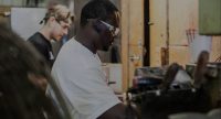 Trusty-Cook employees working wearing protective face gear.