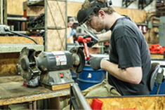 Trusty-Cook employee working on a hammer