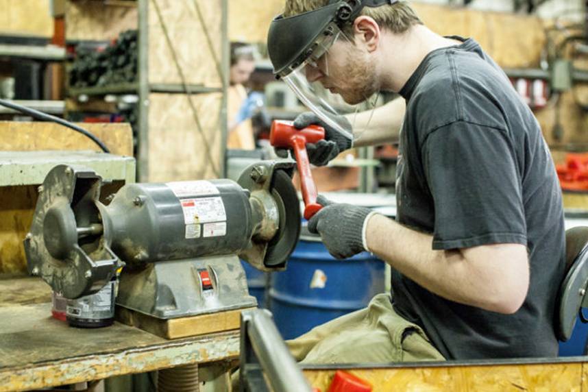 Trusty-Cook employee working on a hammer